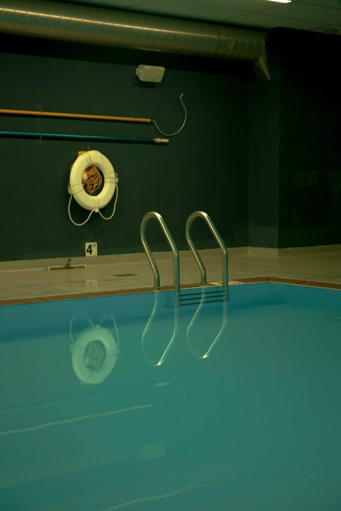 white lifebuoy near swimming pool